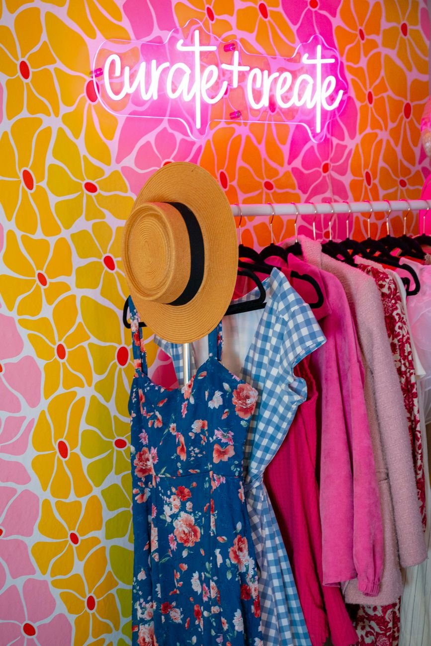 Colourful curated clothes on a fashion rack in a stylish studio